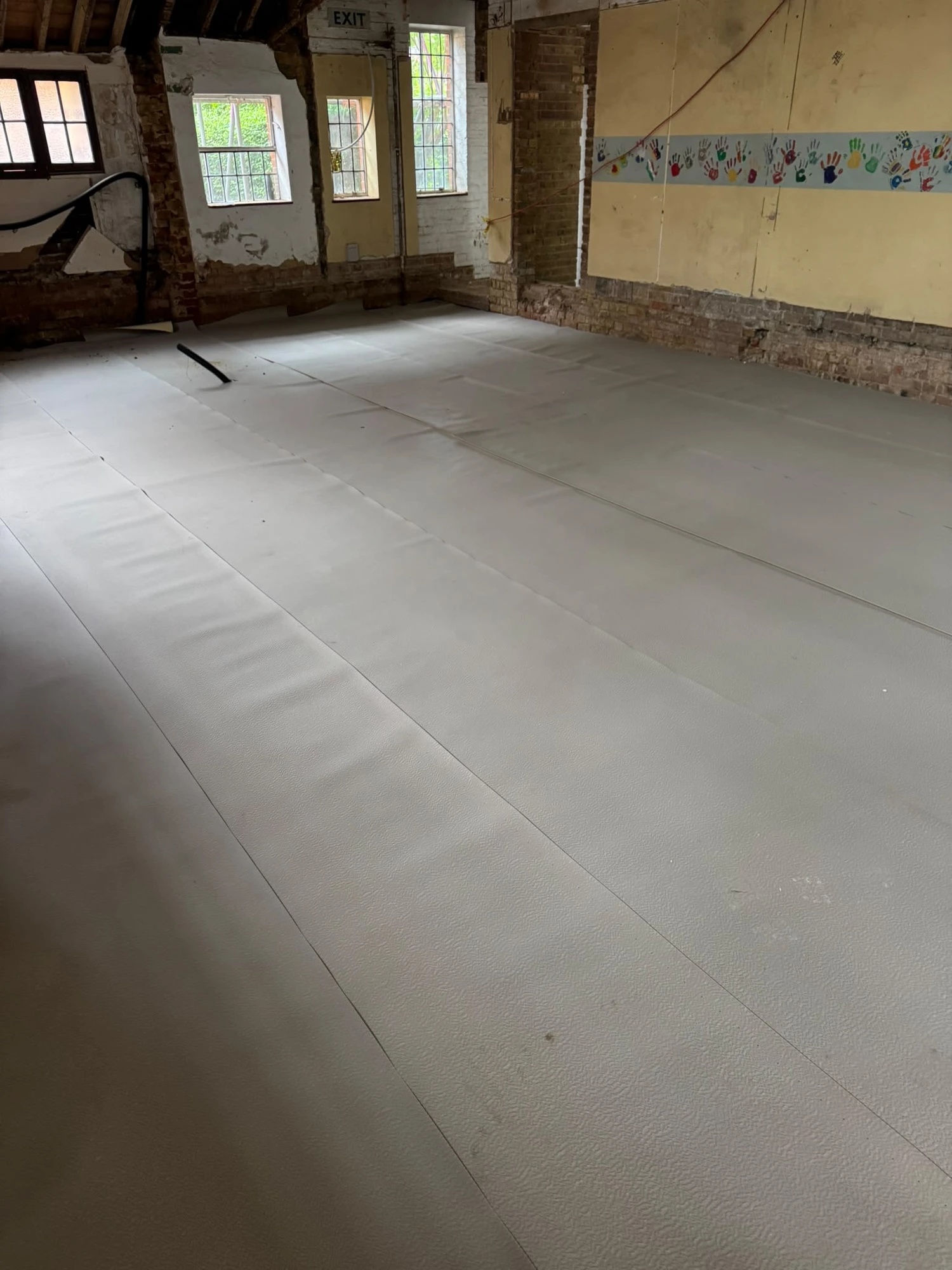 Floor insulation boards installed across the hall at Bishop Stortford