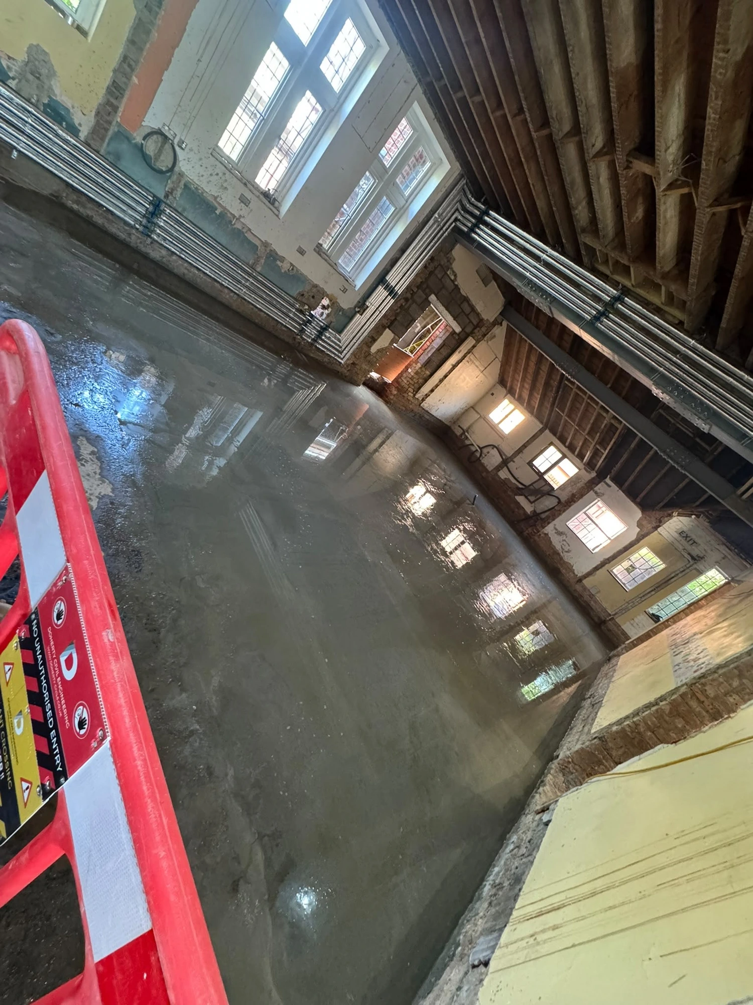 New concrete floor freshly poured across the hall at Bishop Stortford