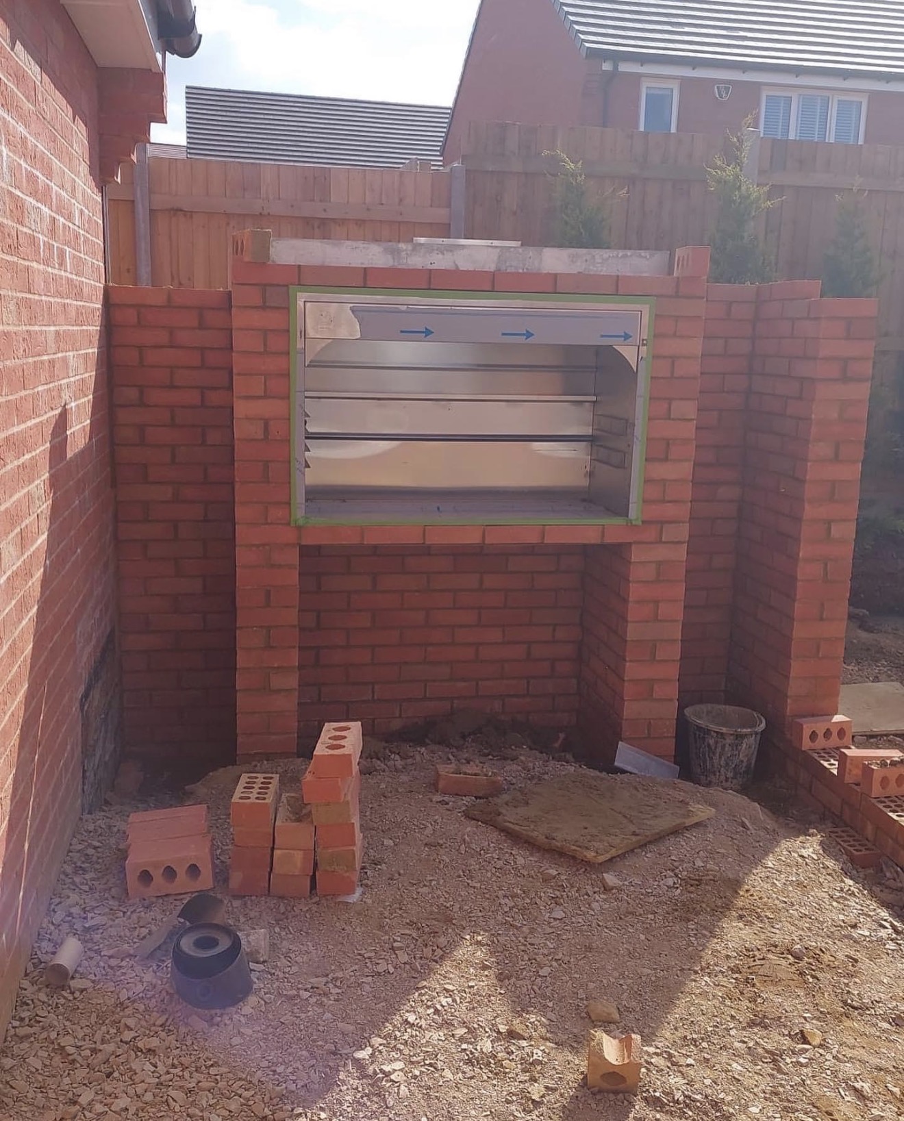 Custom-built brick BBQ with chimney under construction at Buckton Fields