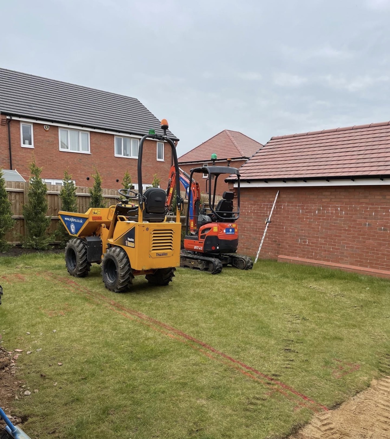 Site set-up with machinery on the existing lawn at Buckton Fields