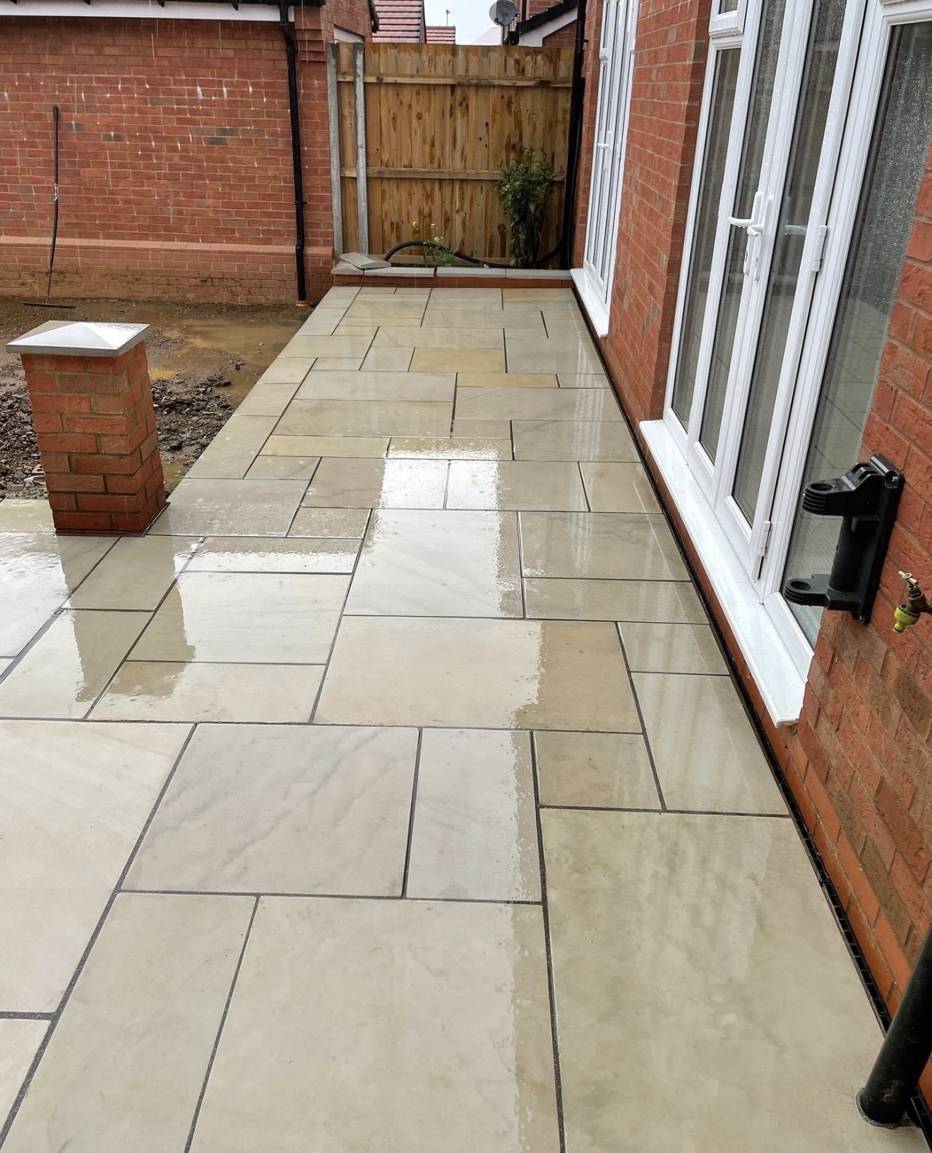 Sawn and honed sandstone paving running along the house at Buckton Fields