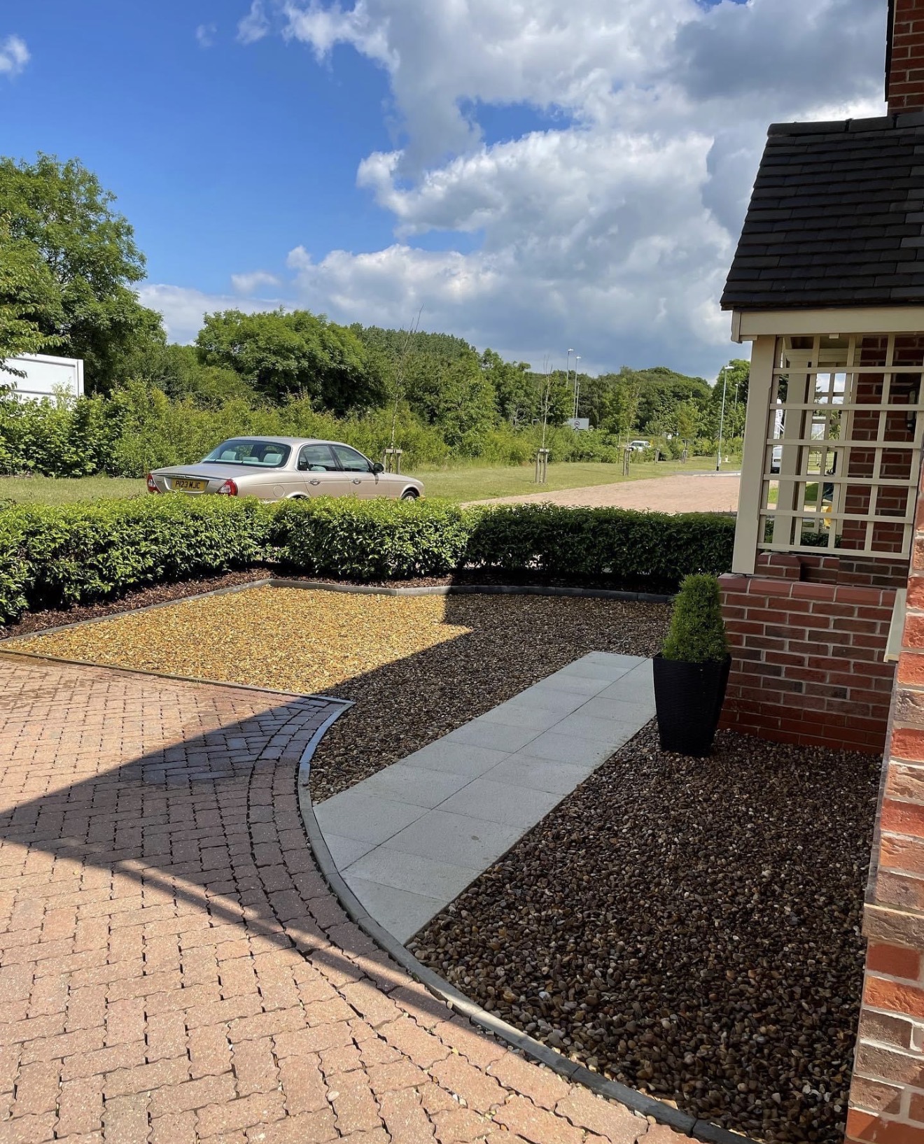 Completed front garden with gravel areas and curved paved pathway in Northampton