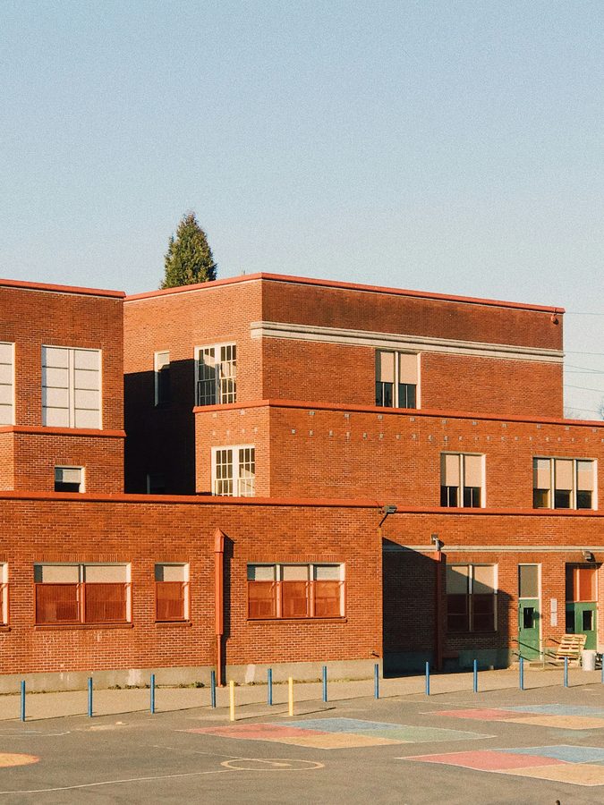 A brick school building exterior during daylight